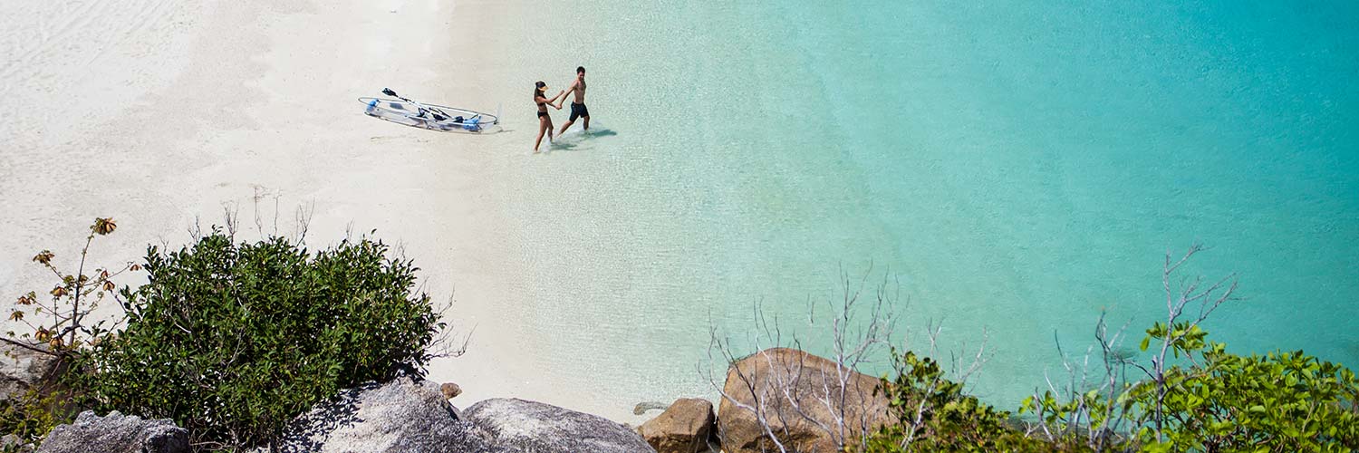Couple walking in the water on Lizard Island