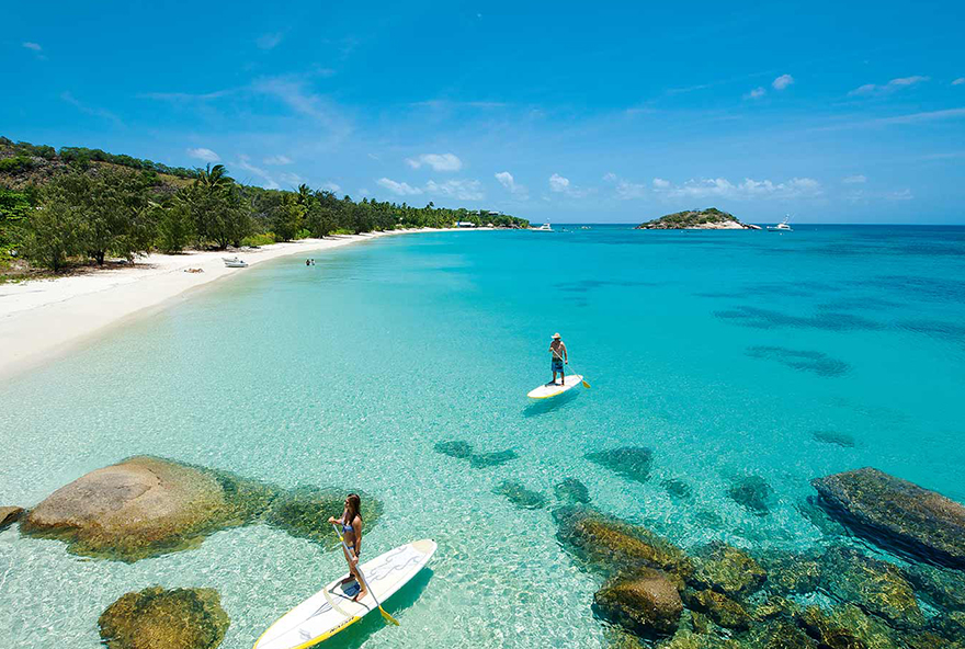 Enjoy a resort activity like stand up paddleboarding off one of Lizard Island's beautiful beaches.