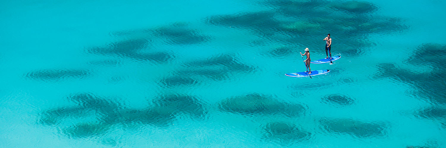 Guest paddle boarding on Anchor Bay, Lizard Island