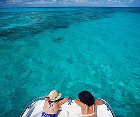Guest floating on a boat on Lizard Island
